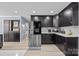 An updated kitchen features stainless steel appliances, dark cabinetry, and marble backsplash at 961 Confederate Ave, Salisbury, NC 28144