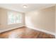 Bedroom with hardwood floors, neutral paint, natural light from one window at 104 Willetta Dr, Charlotte, NC 28217