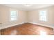 Spacious bedroom with hardwood floors and two windows for natural light at 104 Willetta Dr, Charlotte, NC 28217