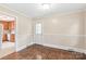 Well-lit dining area featuring hardwood floors and natural lighting with a view into kitchen at 104 Willetta Dr, Charlotte, NC 28217