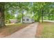 Well-maintained home with inviting curb appeal and mature trees and an extra long driveway at 104 Willetta Dr, Charlotte, NC 28217
