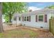 Cozy home with a covered front porch, symmetrical windows, and updated color palette at 104 Willetta Dr, Charlotte, NC 28217