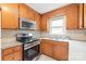 Charming kitchen includes stainless appliances, tile backsplash and ample cabinet space at 104 Willetta Dr, Charlotte, NC 28217