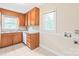 Cozy kitchen features wooden cabinets, tile floor and a window for natural light at 104 Willetta Dr, Charlotte, NC 28217