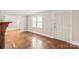 Bright and welcoming living room with hardwood floors and a white entry door at 104 Willetta Dr, Charlotte, NC 28217