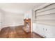 Inviting living room with fireplace, hardwood floors and classic built-in cabinets at 104 Willetta Dr, Charlotte, NC 28217