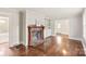 Light filled living room with fireplace, hardwood floors and built in cabinetry at 104 Willetta Dr, Charlotte, NC 28217
