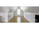 Spacious attic area with hardwood floors, paneled walls and a window at 108 Stockton St, Shelby, NC 28150