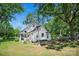 Expansive backyard with mature trees, a pergola, and a firepit, perfect for outdoor entertaining at 108 Stockton St, Shelby, NC 28150
