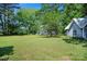 Spacious yard with mature trees; detached building offering versatile outdoor living and recreational opportunities at 108 Stockton St, Shelby, NC 28150