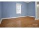 Comfortable bedroom featuring hardwood floors and ample natural light from the window at 108 Stockton St, Shelby, NC 28150