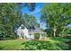 Beautiful white home with dark roof, inviting front porch and lush greenery at 108 Stockton St, Shelby, NC 28150
