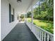 Spacious, covered porch featuring a long view of the green yard and mature trees at 108 Stockton St, Shelby, NC 28150