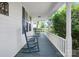 Comfortable covered porch with rocking chairs and plenty of space for outdoor seating at 108 Stockton St, Shelby, NC 28150