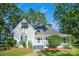 Charming white farmhouse with blue shutters, lush landscaping, and a welcoming front porch at 108 Stockton St, Shelby, NC 28150