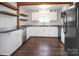 Bright kitchen with stainless steel appliances, tile backsplash, and hardwood floors at 108 Stockton St, Shelby, NC 28150