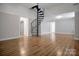 Bright living room showcases hardwood floors and a distinctive spiral staircase at 108 Stockton St, Shelby, NC 28150
