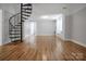 Spacious living room featuring hardwood floors and a unique spiral staircase at 108 Stockton St, Shelby, NC 28150