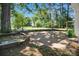 Spacious stone patio with retaining walls, mature shade trees, and classic lamp posts at 108 Stockton St, Shelby, NC 28150