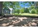 Stone patio showcasing a lamp post and a barn with unique Z doors and lush green lawn at 108 Stockton St, Shelby, NC 28150