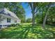 Large, green backyard framed by mature trees, providing a serene and private outdoor space at 108 Stockton St, Shelby, NC 28150
