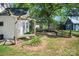 Manicured green yard with a shade structure and view of the barn and stone patio at 108 Stockton St, Shelby, NC 28150