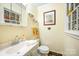 The bathroom has a framed picture and an above-sink mirror cabinet at 1115 Grovewood Dr, Charlotte, NC 28208