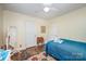 Cozy bedroom with warm colors, ample closet space, and hardwood floors at 1115 Grovewood Dr, Charlotte, NC 28208