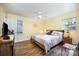 Bedroom features include a ceiling fan, unique lighting, and colorful stained glass window accents at 1115 Grovewood Dr, Charlotte, NC 28208