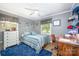 Comfortable bedroom featuring a cozy bed, a work desk, and natural light at 1115 Grovewood Dr, Charlotte, NC 28208
