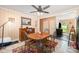 Dining room with wood table, metal chairs, ceiling fan, colorful rug, and adjacent open space at 1115 Grovewood Dr, Charlotte, NC 28208