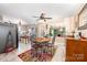 Open dining area featuring a wooden table set, adjacent to a kitchen with modern appliances and cabinetry at 1115 Grovewood Dr, Charlotte, NC 28208