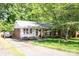 Inviting home with brick accents, well-kept landscaping, and a long driveway leading to the front entrance at 1115 Grovewood Dr, Charlotte, NC 28208
