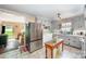 Functional kitchen featuring stainless steel appliances, white cabinets, a dining area, and tile flooring at 1115 Grovewood Dr, Charlotte, NC 28208