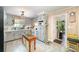 Charming kitchen with gray cabinets, an island table, and stainless steel appliances at 1115 Grovewood Dr, Charlotte, NC 28208