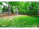 Large backyard with mature trees and a lush green lawn at 12314 Chickasaw Dr, Huntersville, NC 28078