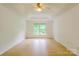 Bright and spacious bedroom with hardwood floors and ceiling fan at 12314 Chickasaw Dr, Huntersville, NC 28078