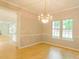 Bright dining area featuring a modern chandelier and large windows at 12314 Chickasaw Dr, Huntersville, NC 28078