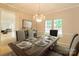 Elegant dining room featuring a wooden table set with fine china and a decorative chandelier at 12314 Chickasaw Dr, Huntersville, NC 28078