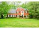 Beautiful two-story brick home with black shutters and mature landscaping at 12314 Chickasaw Dr, Huntersville, NC 28078