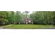 Charming two-story brick home with well-manicured lawn and lush greenery at 12314 Chickasaw Dr, Huntersville, NC 28078