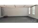 Spacious two-car garage with painted floor, overhead lighting, and ample room for vehicles and storage at 12314 Chickasaw Dr, Huntersville, NC 28078
