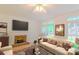 Bright living room features a cozy fireplace and ample natural light from large windows at 12314 Chickasaw Dr, Huntersville, NC 28078