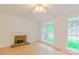 Bright living room with brick fireplace, hardwood flooring and sunlit windows at 12314 Chickasaw Dr, Huntersville, NC 28078