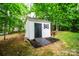 Outdoor shed with a ramp nestled among mature trees at 12314 Chickasaw Dr, Huntersville, NC 28078