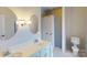 Bright bathroom with a double vanity, modern lighting, and white tiling at 1337 Braeburn Nw Rd, Concord, NC 28027