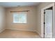 A clean and bright bedroom with neutral carpet and a window with natural light at 1337 Braeburn Nw Rd, Concord, NC 28027