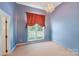 Bright bedroom featuring a modern chandelier, a large window, and light blue walls at 1337 Braeburn Nw Rd, Concord, NC 28027