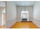 Dining room with hardwood floors, white walls, a window, and a hanging chandelier at 1337 Braeburn Nw Rd, Concord, NC 28027