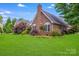 Beautiful brick home showcasing architectural details, manicured landscaping, and a spacious backyard at 1337 Braeburn Nw Rd, Concord, NC 28027